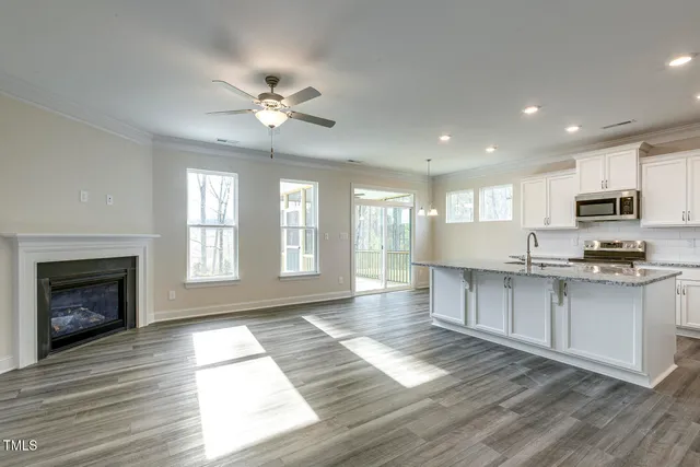 wooden floor fireplace and windows in an empty room