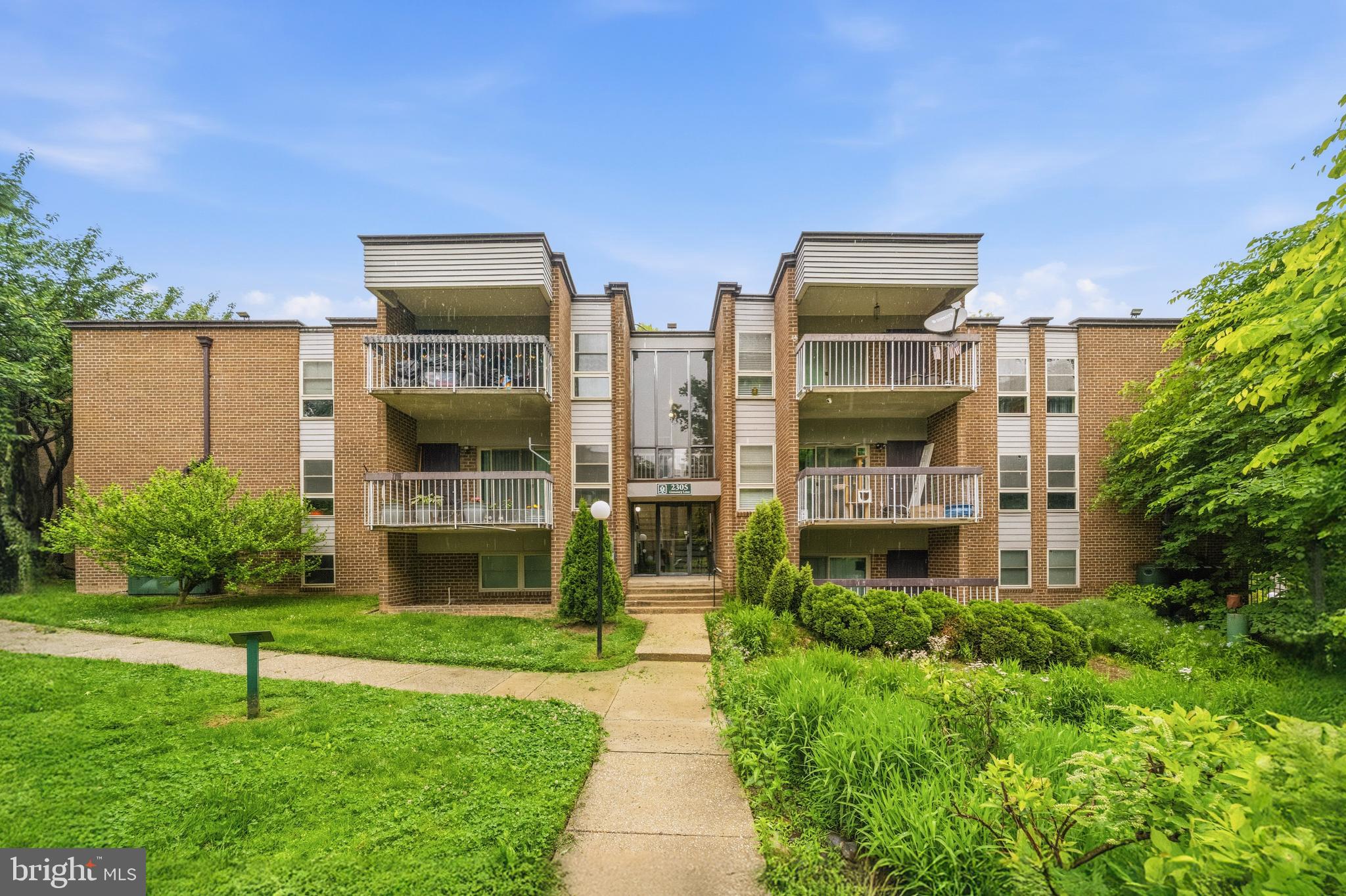 2305 Greenery Lane, Unit T23 Silver Spring, MD 20906 - Photo 1 of 40 a view of building with yard