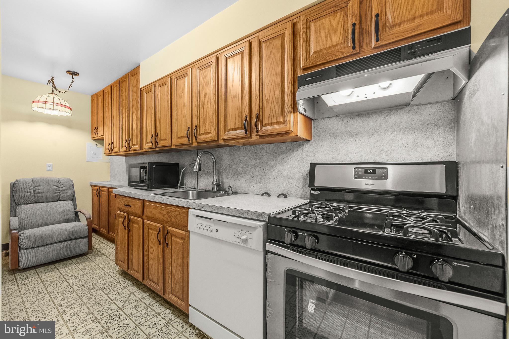 2305 Greenery Lane, Unit T23 Silver Spring, MD 20906 - Photo 16 of 40 a kitchen with stainless steel appliances granite countertop a stove and a white cabinets