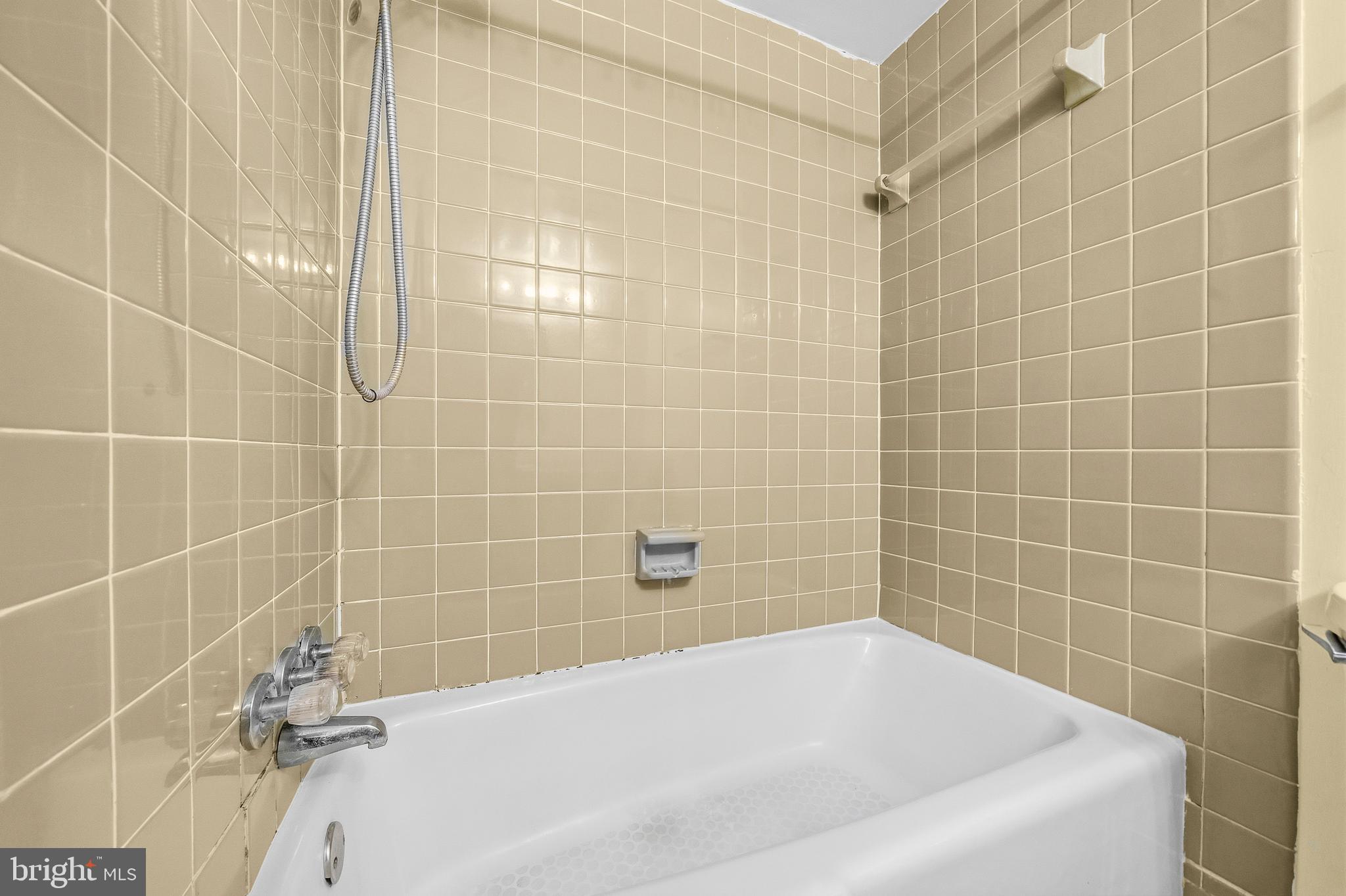 2305 Greenery Lane, Unit T23 Silver Spring, MD 20906 - Photo 27 of 40 a white bath tub sitting in a bathroom
