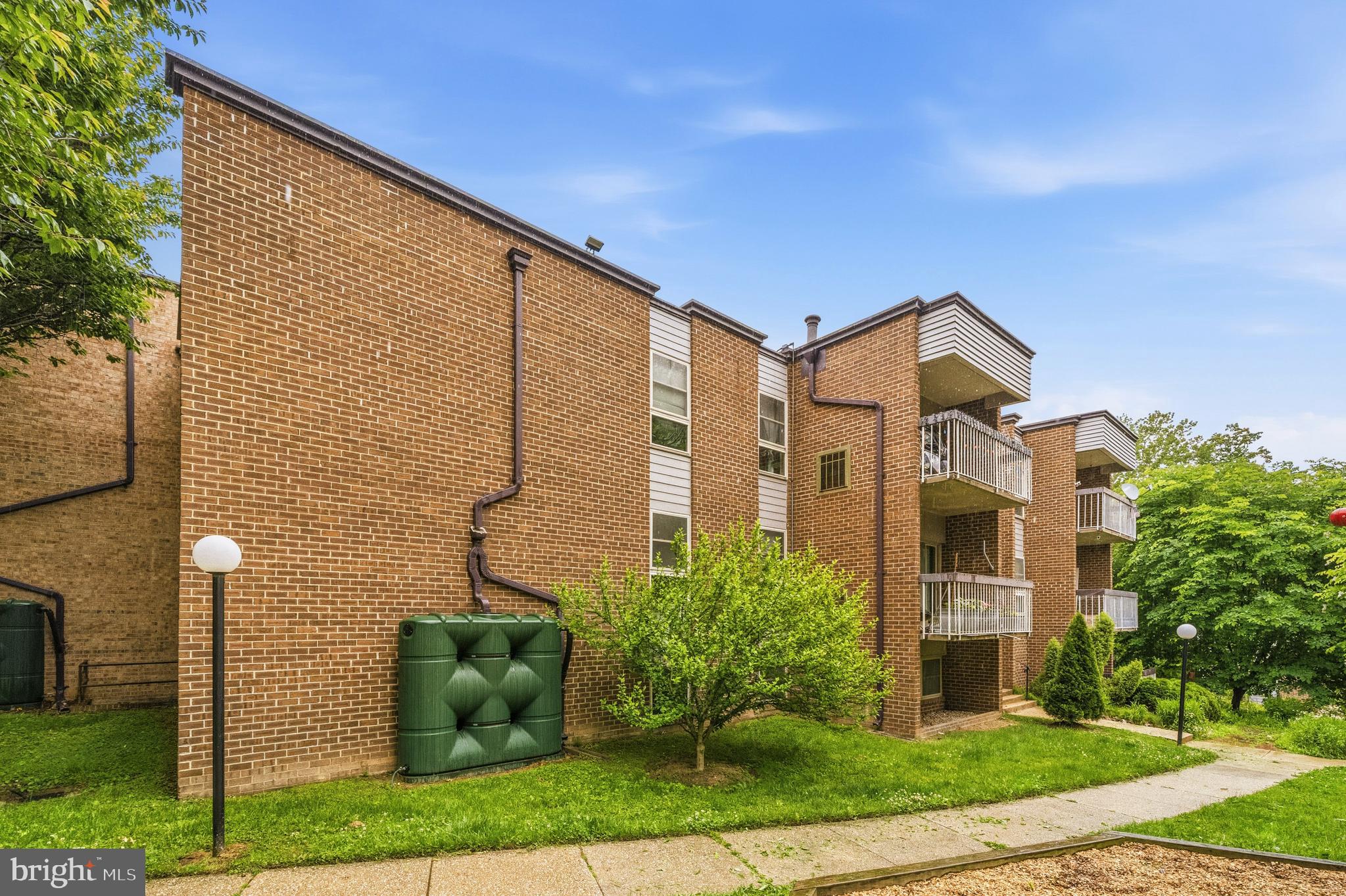 2305 Greenery Lane, Unit T23 Silver Spring, MD 20906 - Photo 3 of 40 a front view of a house with a yard