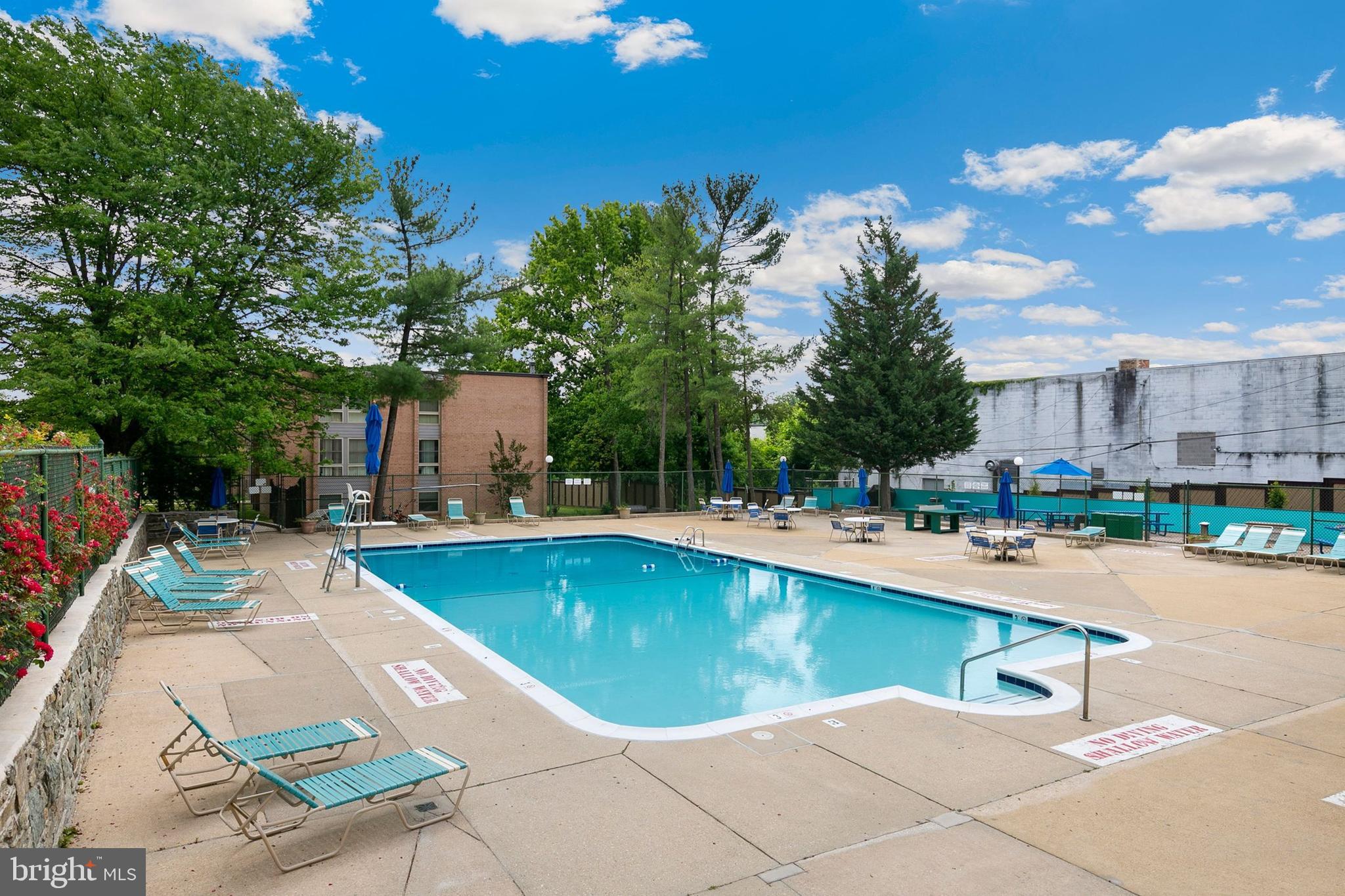 2305 Greenery Lane, Unit T23 Silver Spring, MD 20906 - Photo 31 of 40 a swimming pool with outdoor seating and yard