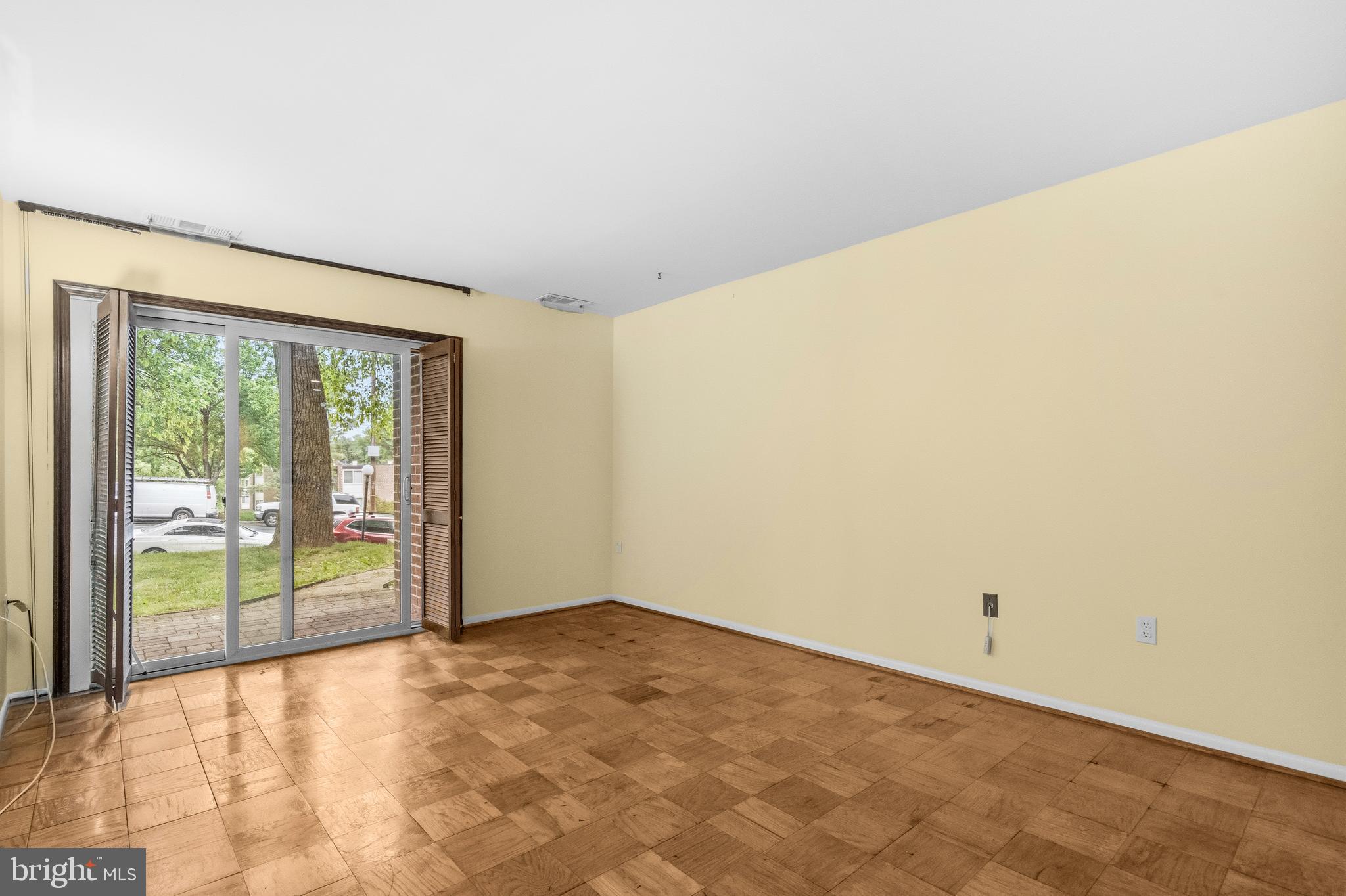 2305 Greenery Lane, Unit T23 Silver Spring, MD 20906 - Photo 7 of 40 a view of an empty room with wooden floor and a window