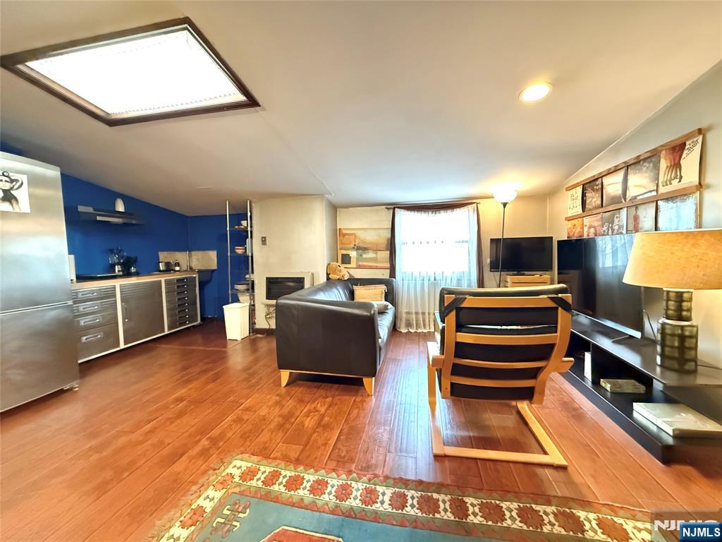 799 2nd Street Secaucus, NJ 07094 - Photo 18 of 48 a living room with stainless steel appliances furniture a flat screen tv and a kitchen view