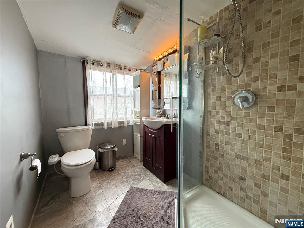 799 2nd Street Secaucus, NJ 07094 - Photo 23 of 48 a bathroom with a toilet sink and shower
