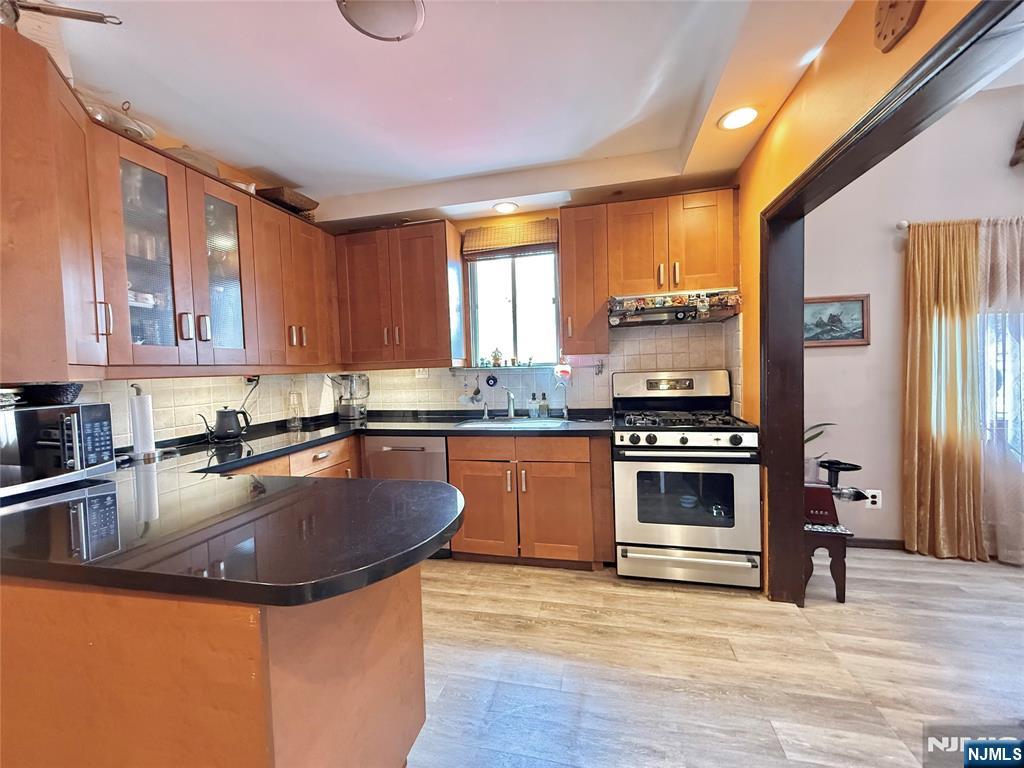 799 2nd Street Secaucus, NJ 07094 - Photo 28 of 48 a kitchen with stainless steel appliances granite countertop a sink stove and refrigerator