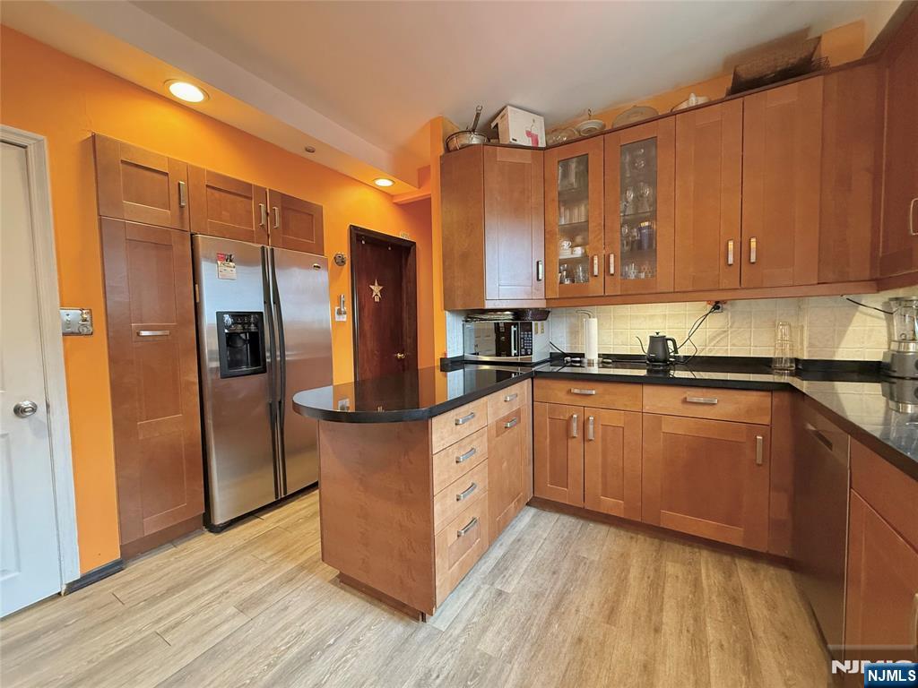 799 2nd Street Secaucus, NJ 07094 - Photo 29 of 48 a kitchen with stainless steel appliances granite countertop a refrigerator a sink and wooden cabinets