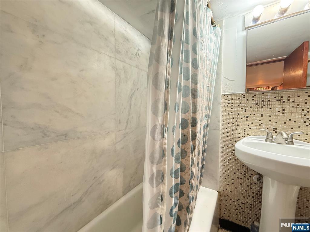 799 2nd Street Secaucus, NJ 07094 - Photo 41 of 48 a bathroom with a sink a toilet and shower