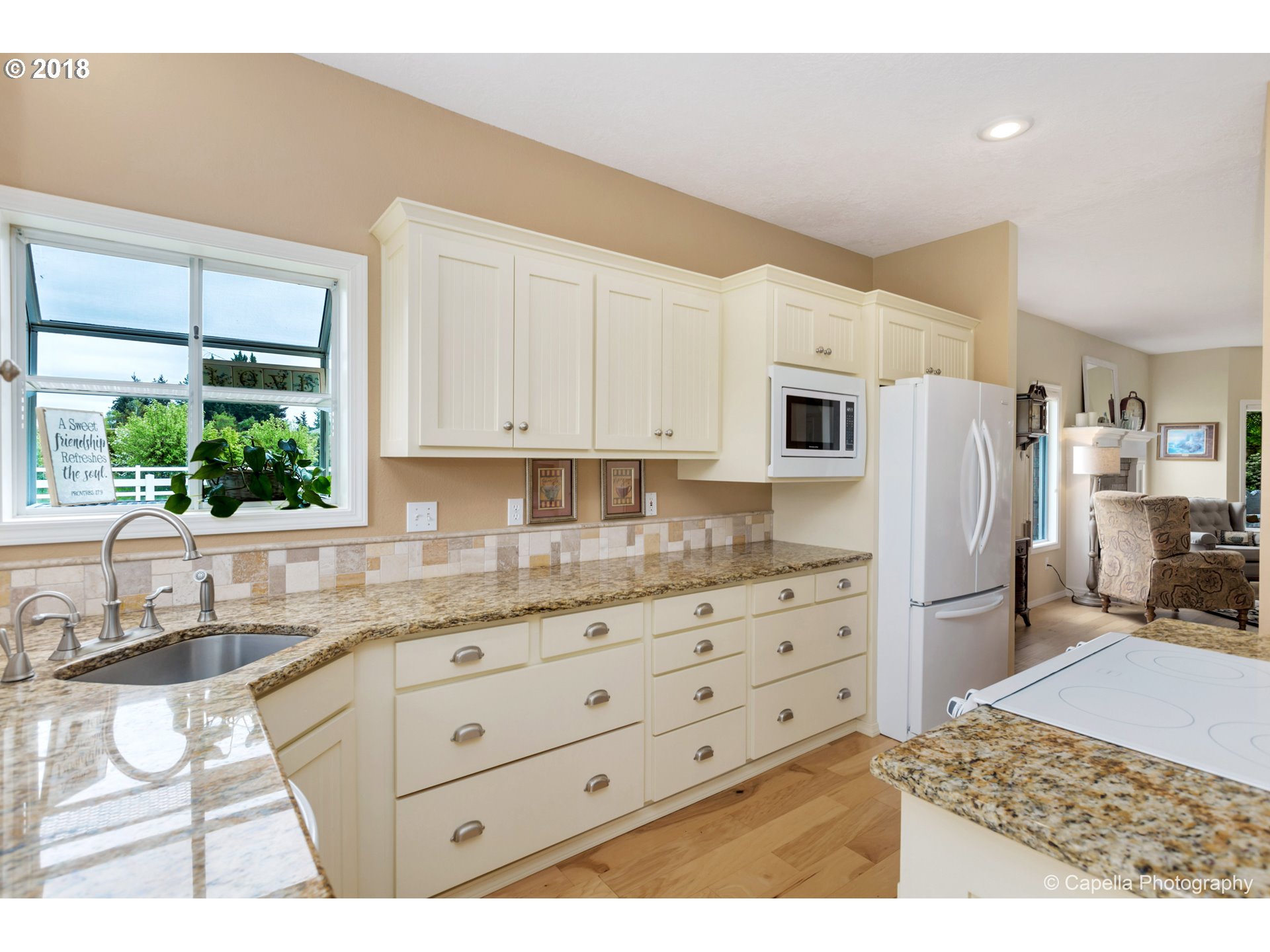 11675 Hazelgreen Road Northeast Silverton, OR 97381 - Photo 11 of 32 a kitchen with granite countertop a refrigerator and a sink