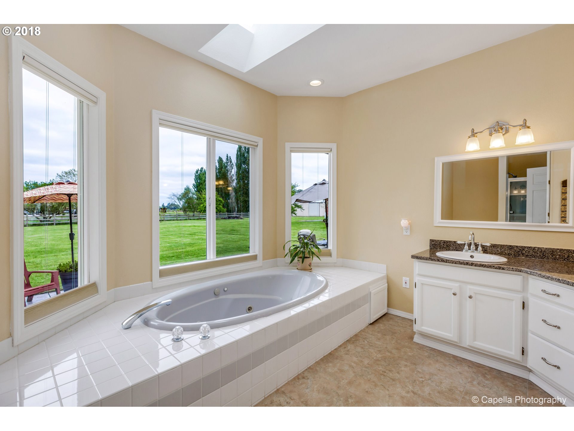 11675 Hazelgreen Road Northeast Silverton, OR 97381 - Photo 15 of 32 a en suite bathroom with a large tub sink and mirror