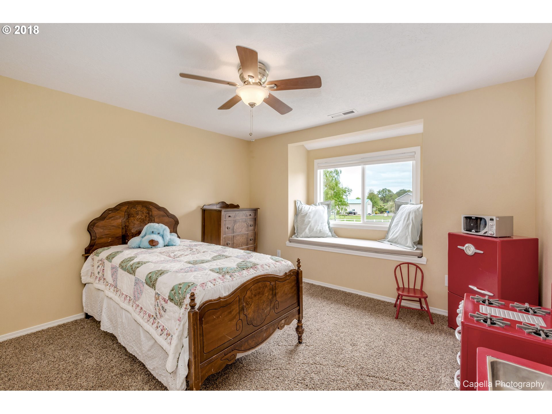 11675 Hazelgreen Road Northeast Silverton, OR 97381 - Photo 17 of 32 a bedroom with a bed and a window
