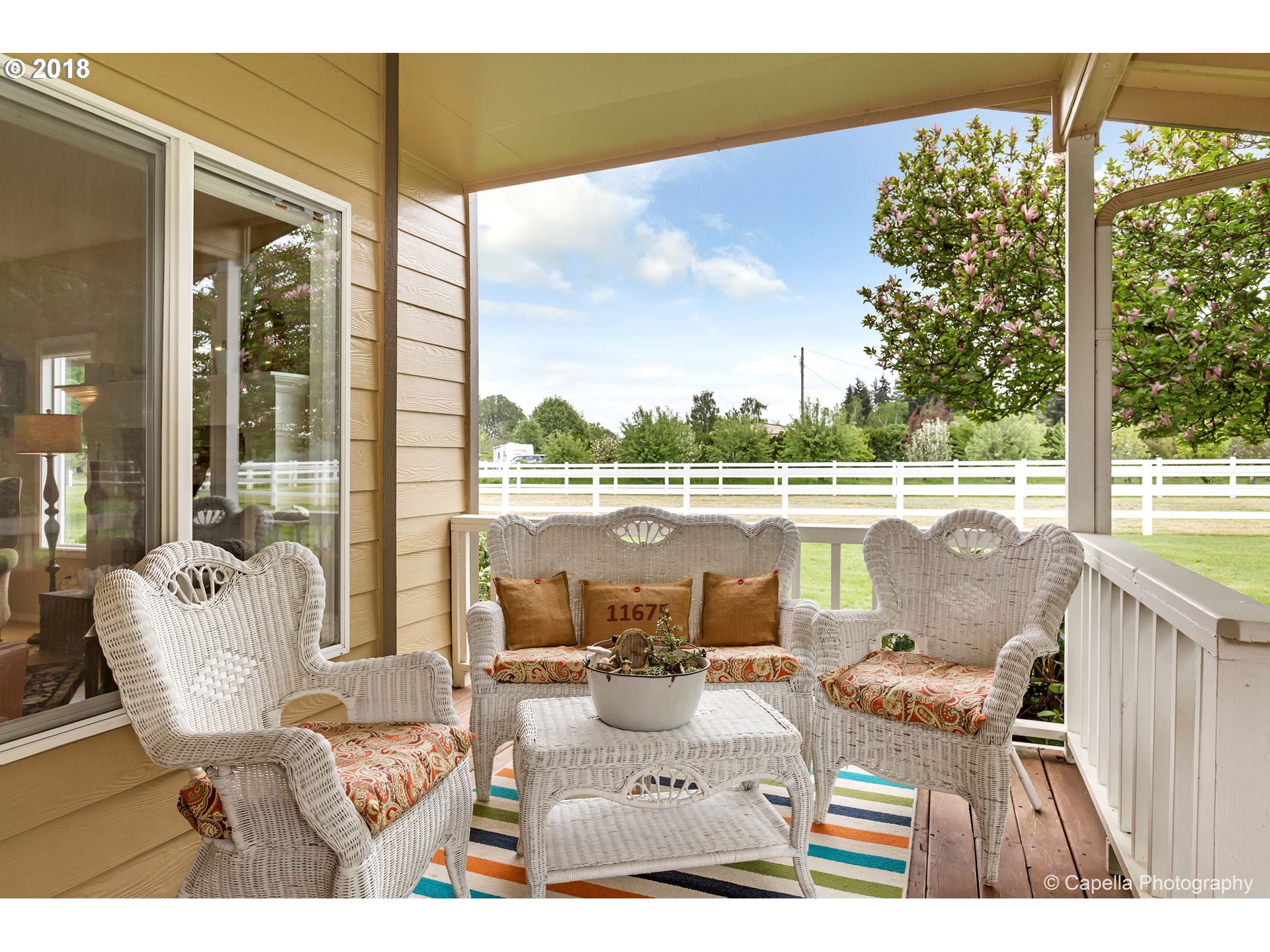 11675 Hazelgreen Road Northeast Silverton, OR 97381 - Photo 4 of 32 a balcony with furniture and a table