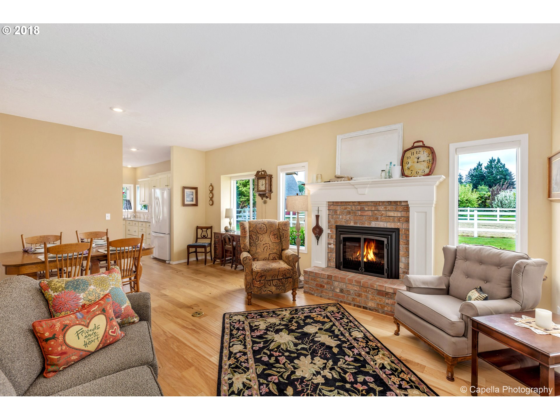 11675 Hazelgreen Road Northeast Silverton, OR 97381 - Photo 6 of 32 a living room with furniture a fireplace and a large window