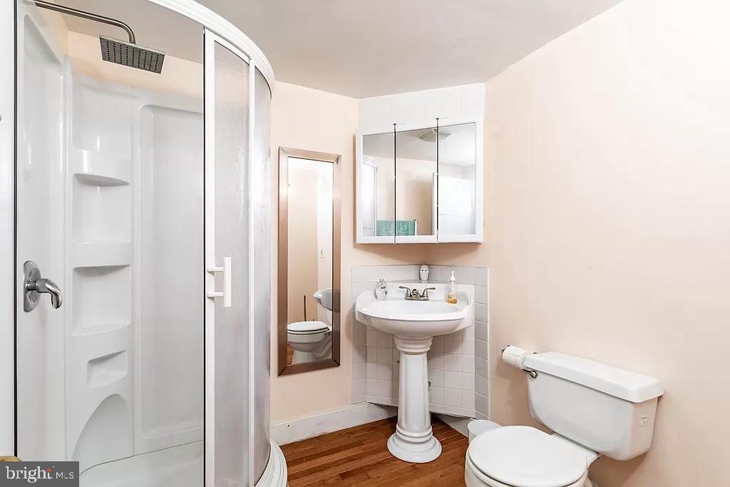 24171 Adelaide Street Parksley, VA 23421 - Photo 11 of 40 a white toilet sitting next to a bathroom sink