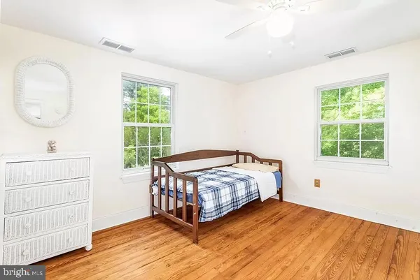 a bedroom with a bed window and a mirror