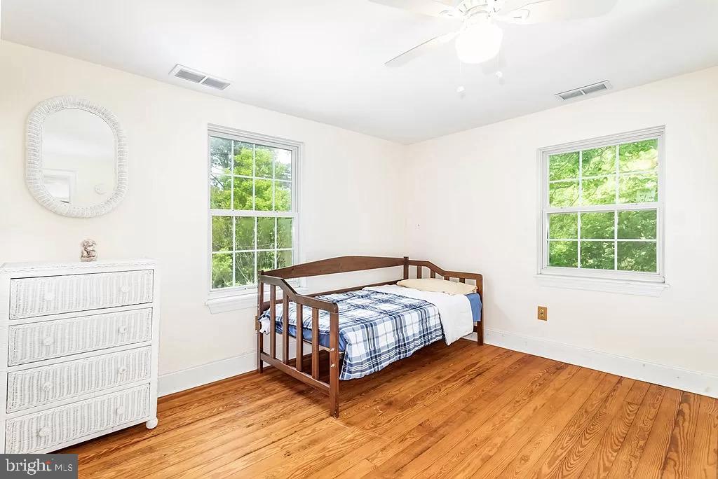 24171 Adelaide Street Parksley, VA 23421 - Photo 14 of 40 a bedroom with a bed window and a mirror