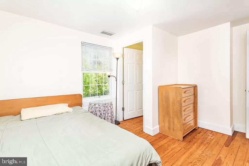 24171 Adelaide Street Parksley, VA 23421 - Photo 16 of 40 a bedroom with a bed and a window