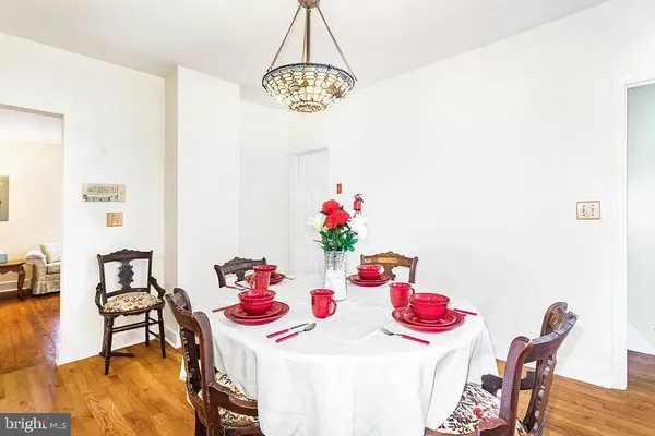 a view of a dining room with furniture and chandelier