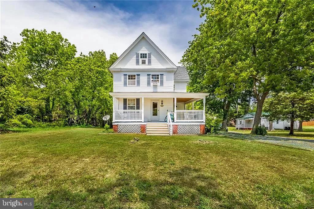 24171 Adelaide Street Parksley, VA 23421 - Photo 2 of 40 a view of a house with a big yard and large trees