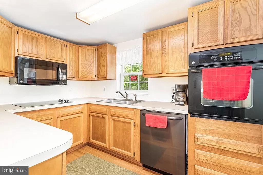 24171 Adelaide Street Parksley, VA 23421 - Photo 23 of 40 a kitchen with stainless steel appliances granite countertop a stove a sink and a microwave