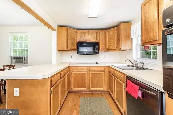 a kitchen with stainless steel appliances granite countertop a sink and a stove