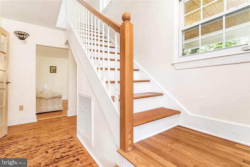 24171 Adelaide Street Parksley, VA 23421 - Photo 29 of 40 a view of a hallway with wooden floor and staircase