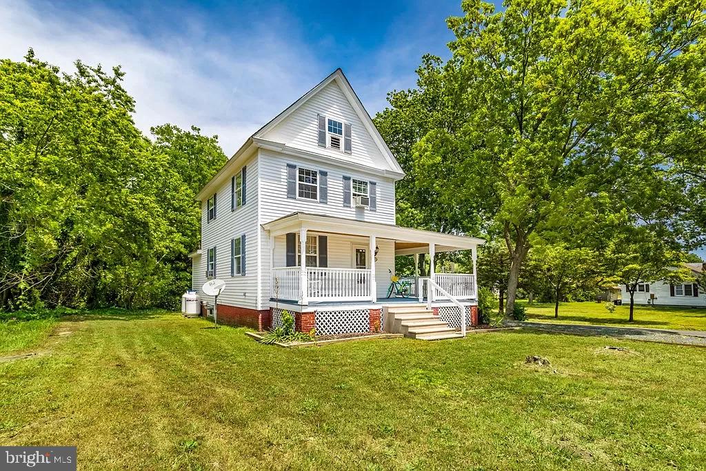 24171 Adelaide Street Parksley, VA 23421 - Photo 3 of 40 a front view of a house with a yard