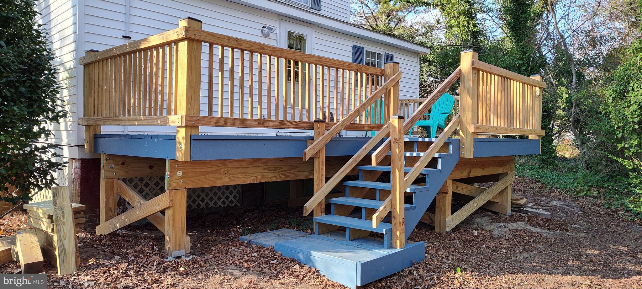 24171 Adelaide Street Parksley, VA 23421 - Photo 8 of 40 a backyard of a house with wooden stairs and a bench