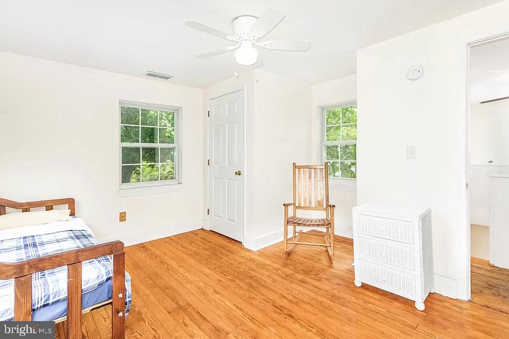 24171 Adelaide Street Parksley, VA 23421 - Photo 9 of 40 a bedroom with a bed and a window