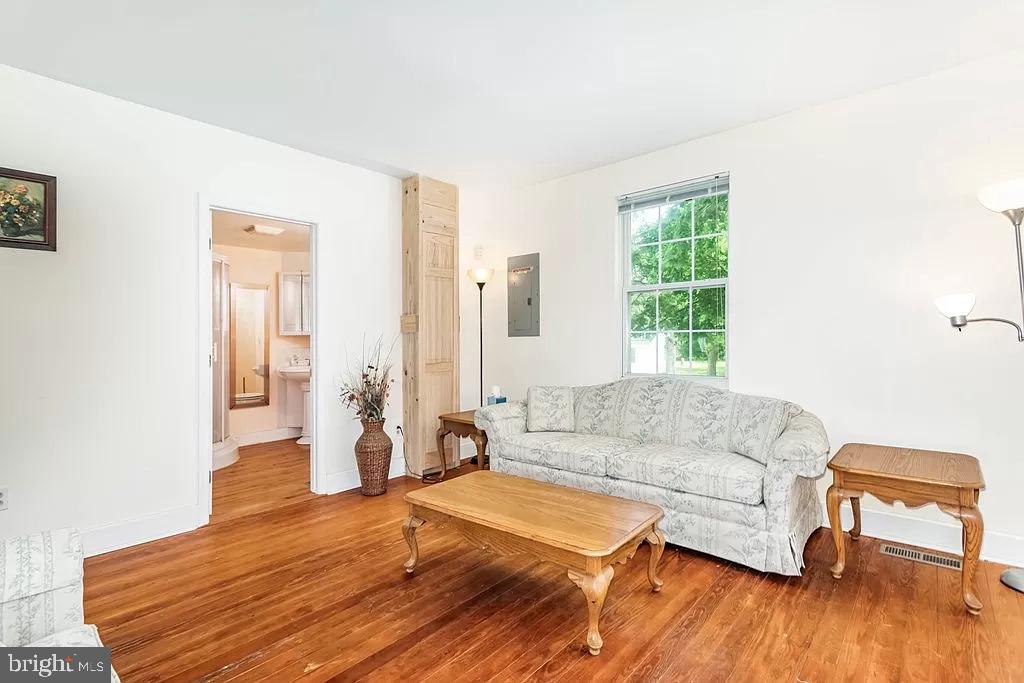 24171 Adelaide Street Parksley, VA 23421 - Photo 10 of 40 a living room with furniture and a wooden floor