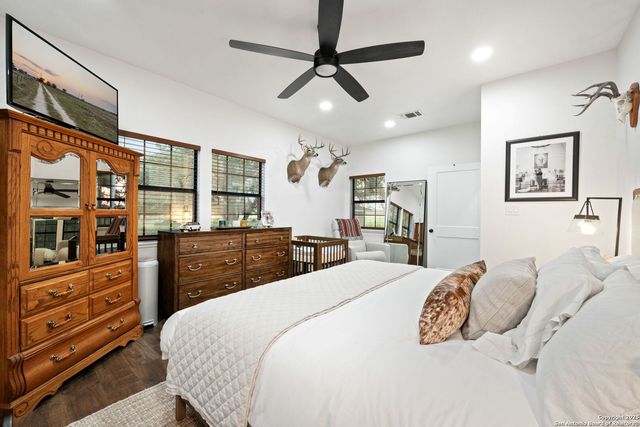 a bedroom with a large bed and a dresser