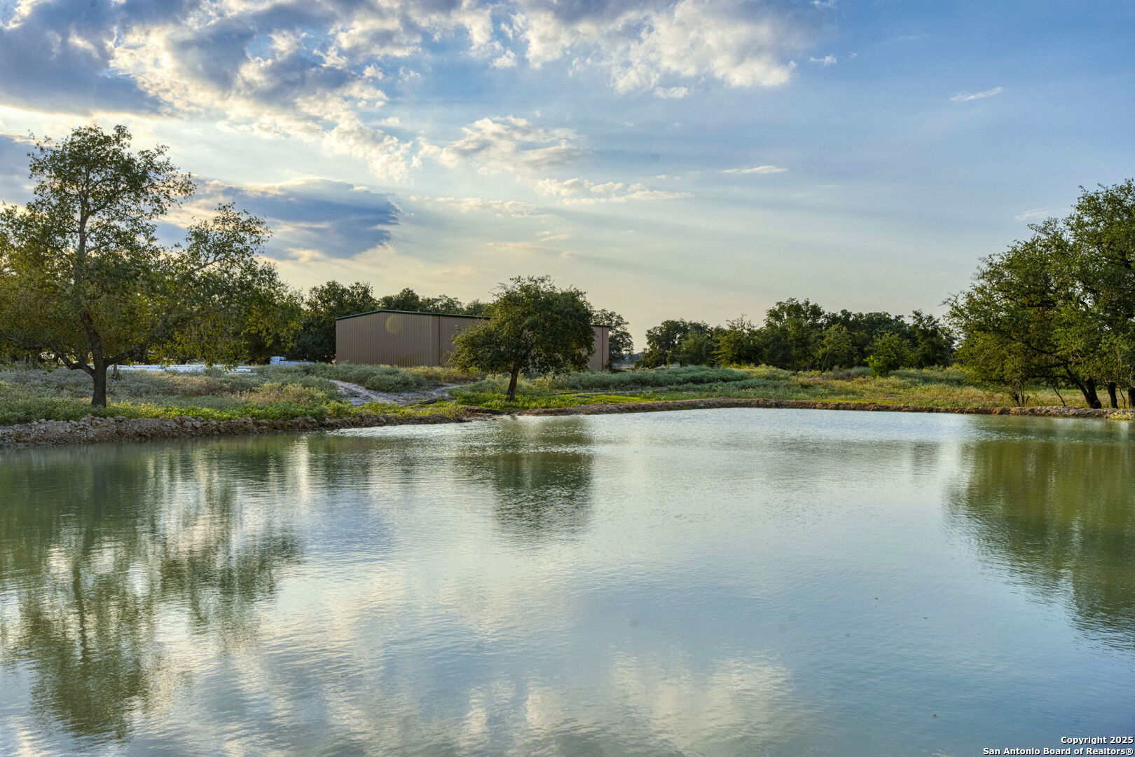 2605 Schuttig Road Pleasanton, TX 78064 - Photo 30 of 35 a view of a lake with a yard