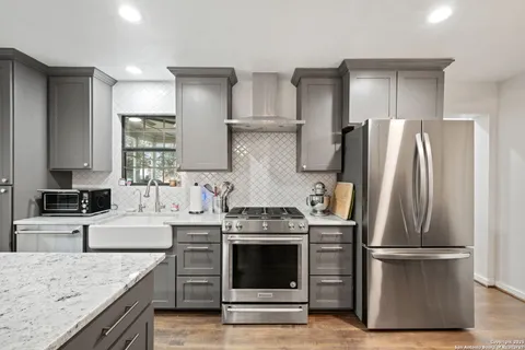 a kitchen with stainless steel appliances granite countertop a refrigerator stove and oven