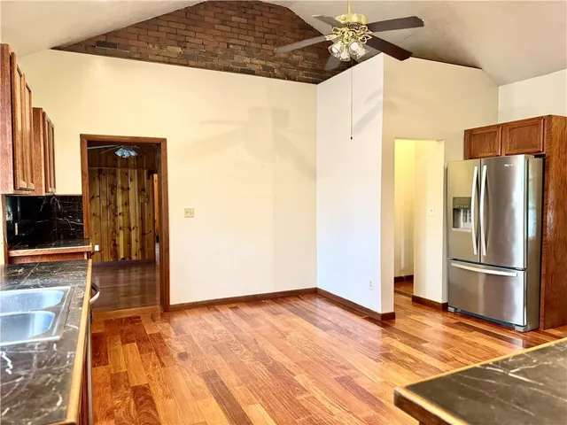 a view of a refrigerator in kitchen and wooden floor