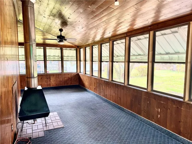 a bedroom with furniture and large windows
