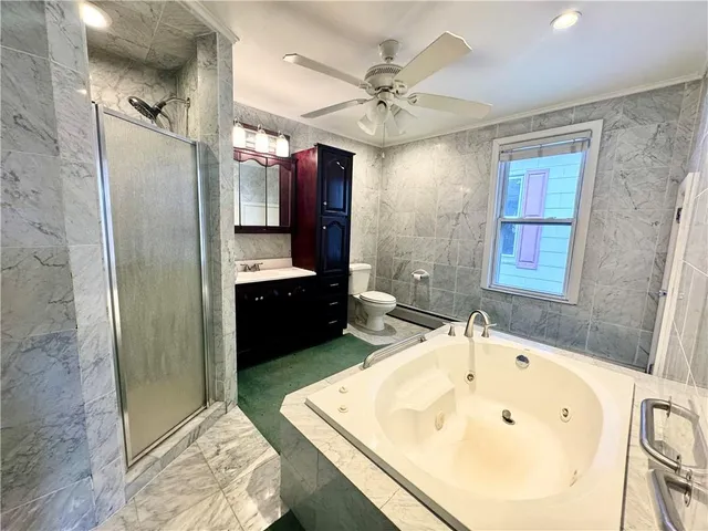 a bathroom with a tub sink and mirror