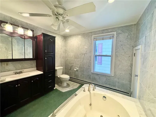 a bathroom with a sink bathtub and a toilet