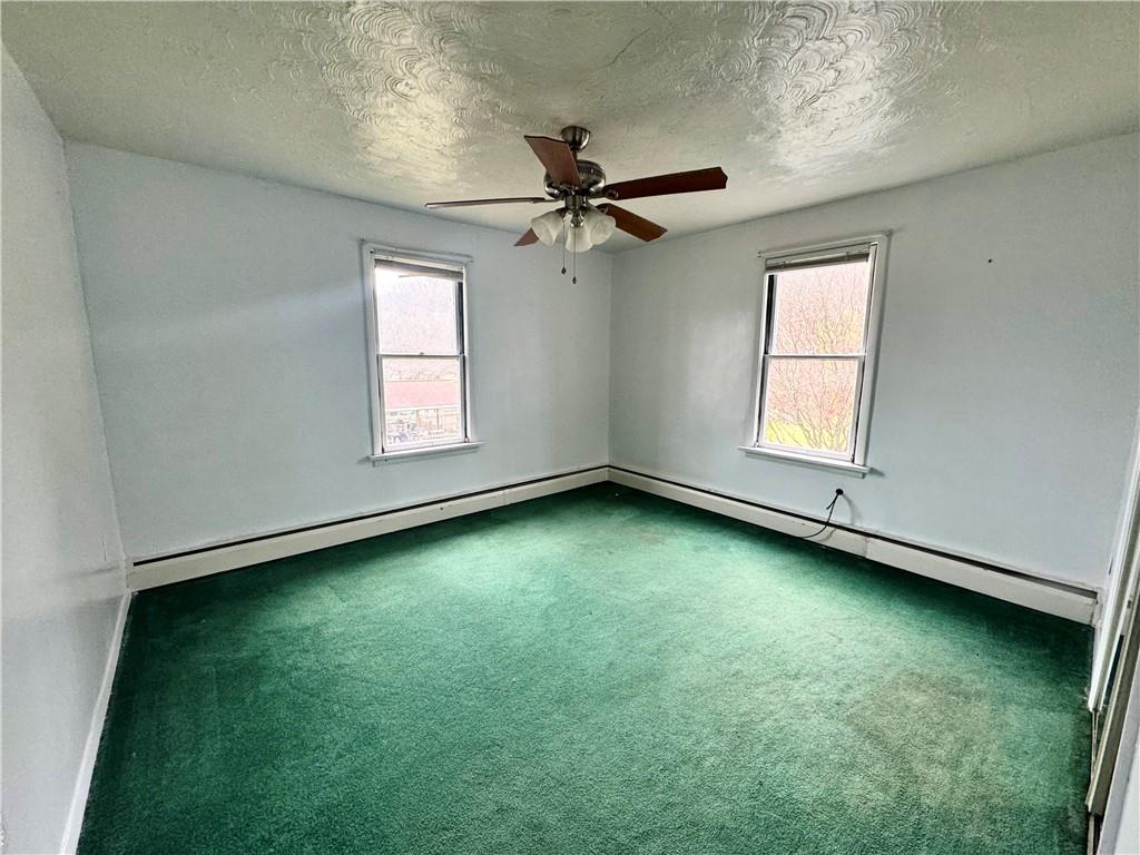 426 Beaver Street Wampum, PA 16157 - Photo 19 of 23 an empty room with a window and a ceiling fan