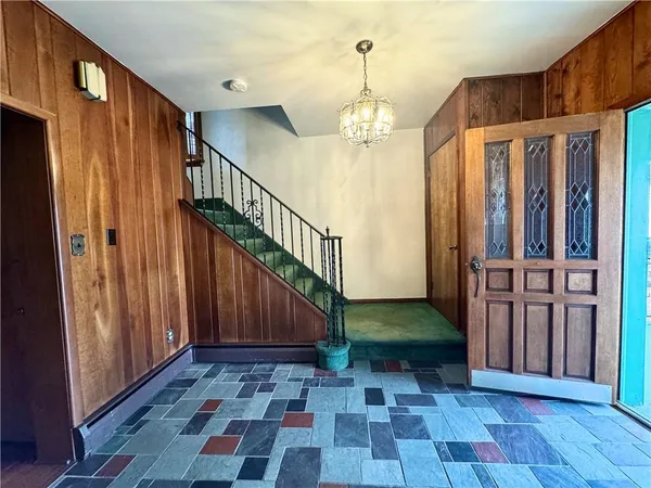 a view of entryway with wooden floor and stairs
