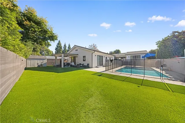 a view of a white house with a swimming pool