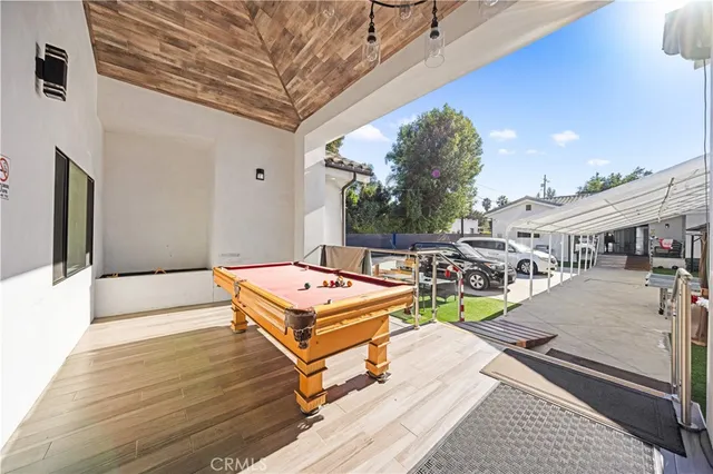 a terrace with outdoor seating and trees
