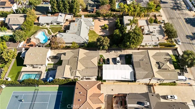 an aerial view of residential houses with outdoor space and parking