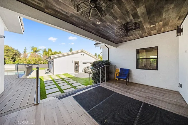 a view of a porch with furniture and a table