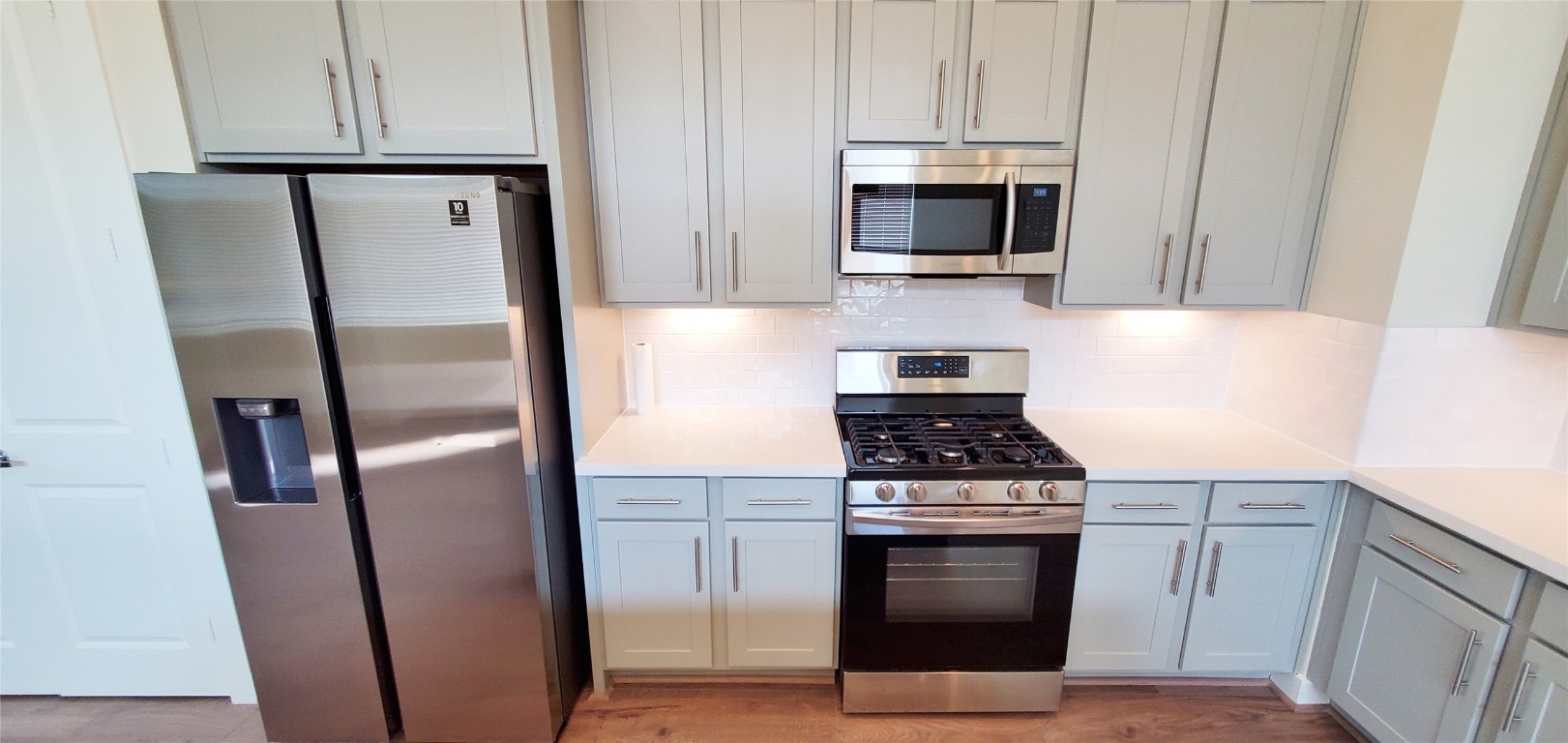 2980 Alice Street Houston, TX 77054 - Photo 6 of 20 a kitchen with stainless steel appliances wooden floor sink and stove