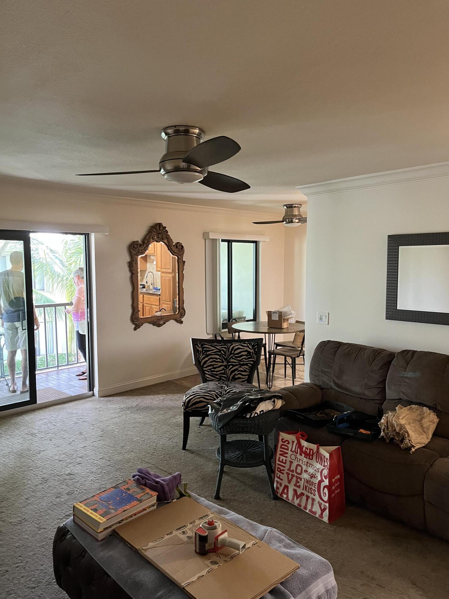 150 Pineview Road, Unit B7 Jupiter, FL 33469 - Photo 3 of 11 a living room with furniture and a large window