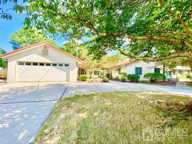 166 Lloyd Road Aberdeen, NJ 07747 - Photo 1 of 56 a front view of a house with a yard and trees