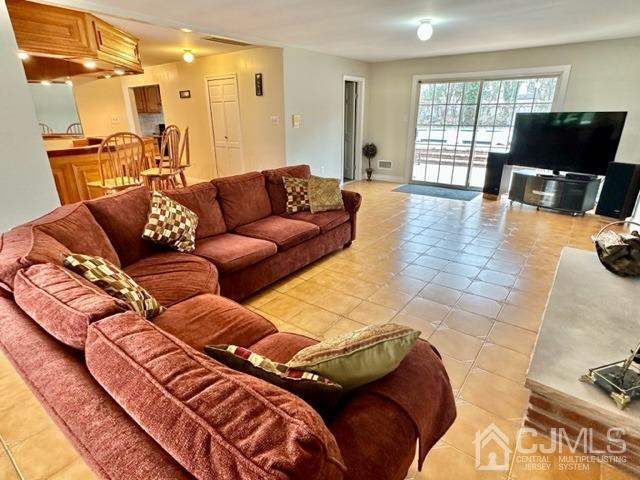 166 Lloyd Road Aberdeen, NJ 07747 - Photo 14 of 56 a living room with furniture and a flat screen tv