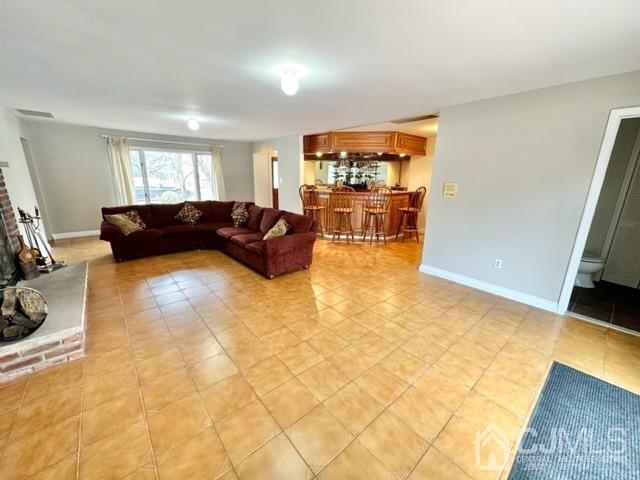 166 Lloyd Road Aberdeen, NJ 07747 - Photo 16 of 56 a living room with furniture and a flat screen tv