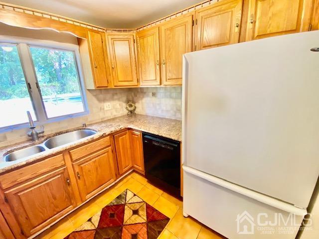 166 Lloyd Road Aberdeen, NJ 07747 - Photo 19 of 56 a kitchen with a sink and a refrigerator