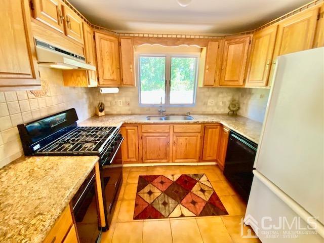 166 Lloyd Road Aberdeen, NJ 07747 - Photo 20 of 56 a kitchen with a sink stove and cabinets
